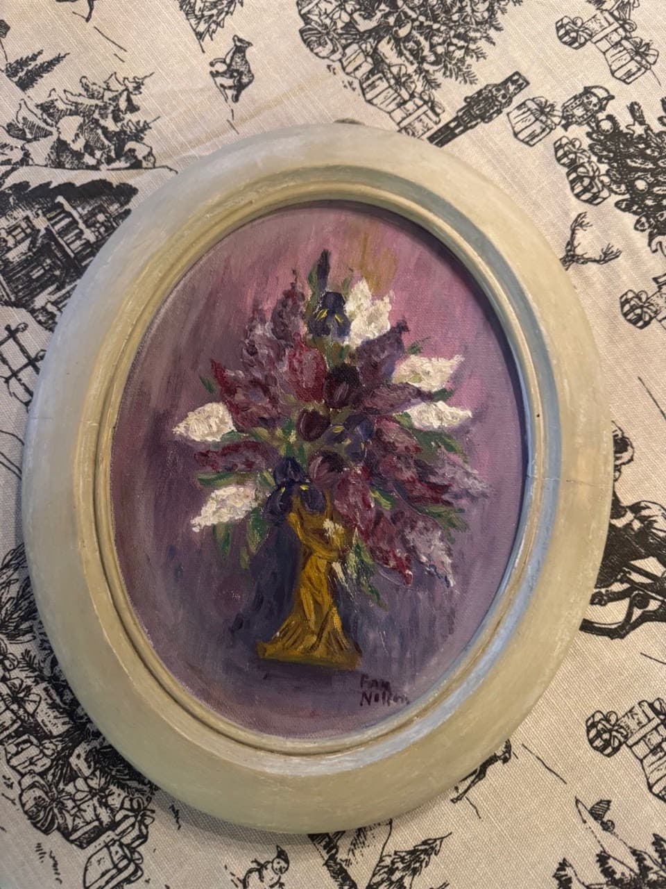 A small oval painting of a flower bouquet in a yellow vase against a purple background.